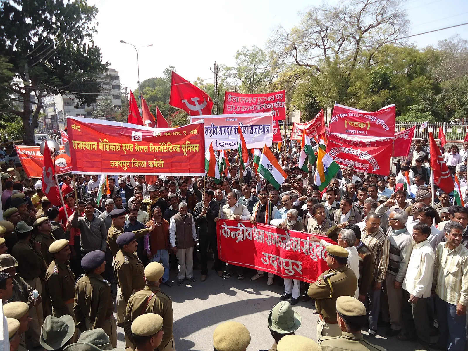 A rally of trade unions in India, marchers with union flags and banners